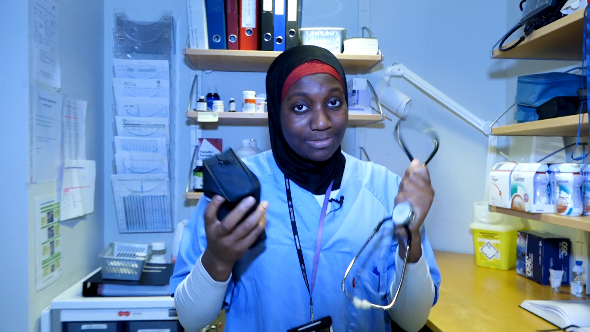 en kvinnelig helsearbeider holder fram et stetoskop og en toalettmappe