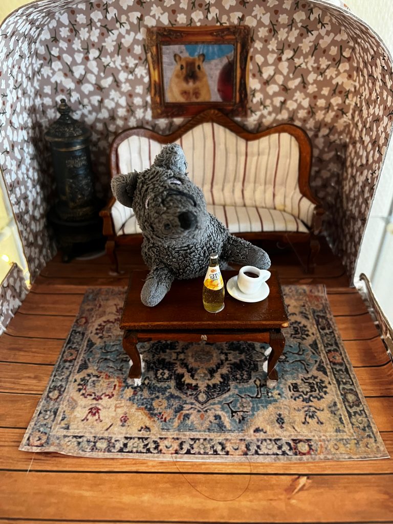 Foto av innhold i eventyrkoffert med dyr i stue.