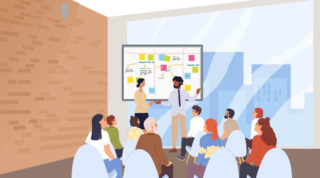 Illustrasjon av en gruppe mennesker. Ved en tavle står ei kvinne og en mann. De underviser eller snakker om et tema. De ser utover en gruppe mennesker som sitter på stoler og ser på de to som står ved tavla. Alle personene er voksne, de er et personale ved en skole eller skoleledere på et møte.
