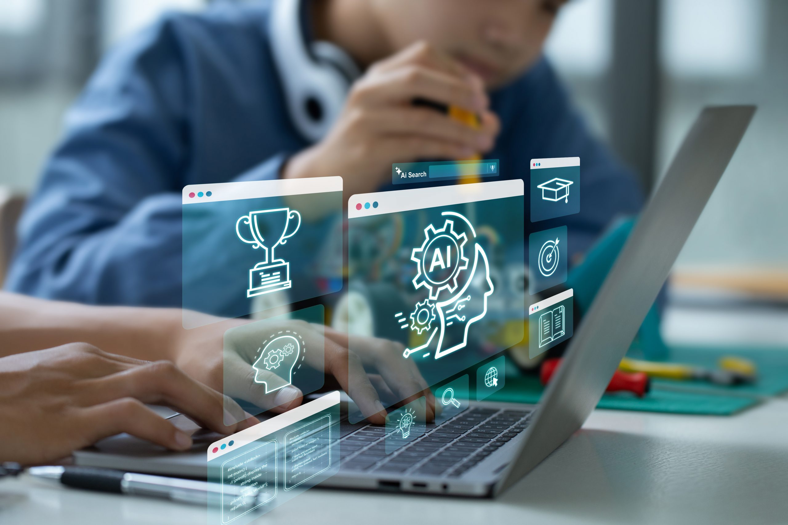 Foto av to elever som ser på en laptop med illustrasjoner av KI: